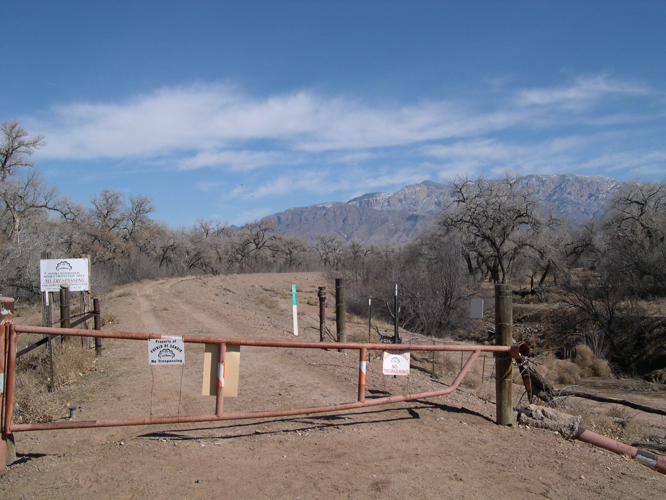 Sandia Reservation border gate on the levee with Sandia Mts.